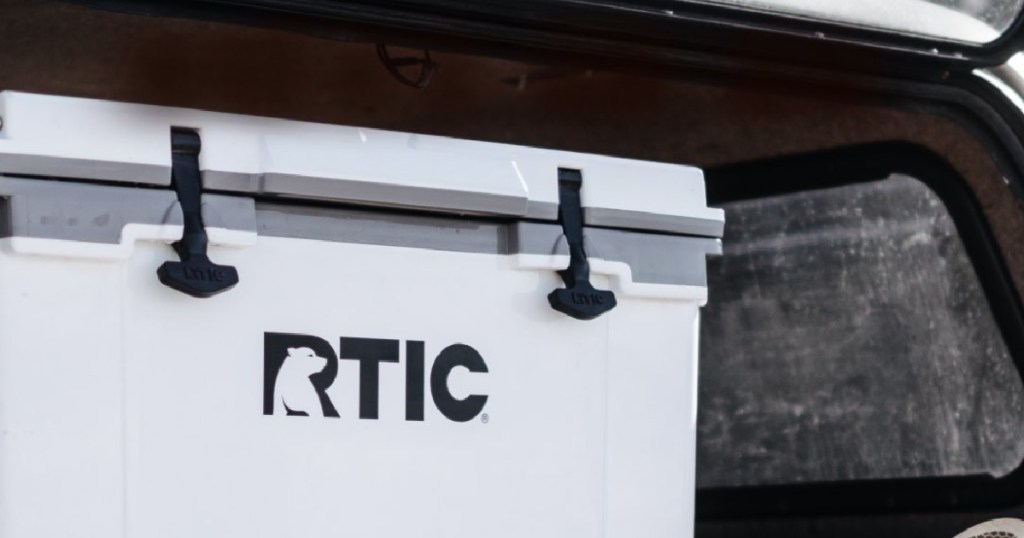 large white cooler in the trunk of a truck