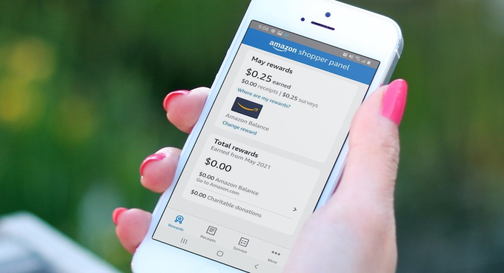 hand holding phone with amazon shopper panel balance on screen