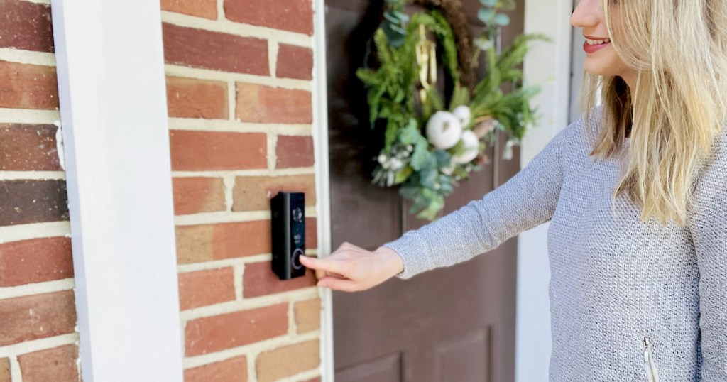 woman pushing on eufy video doorbell