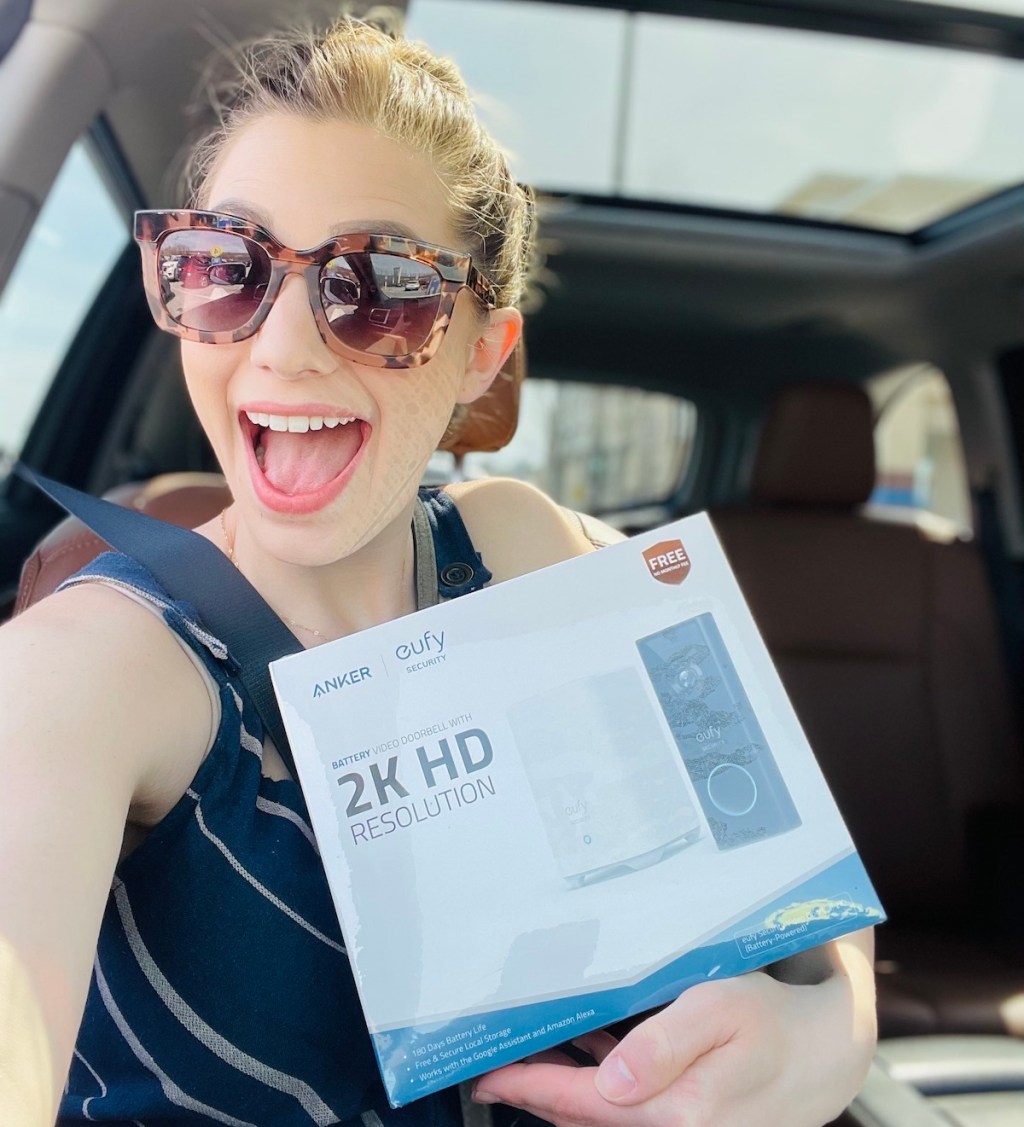 woman holding eufy video doorbell in box