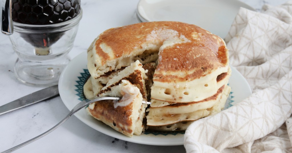 taking a bite of homemade pancakes 