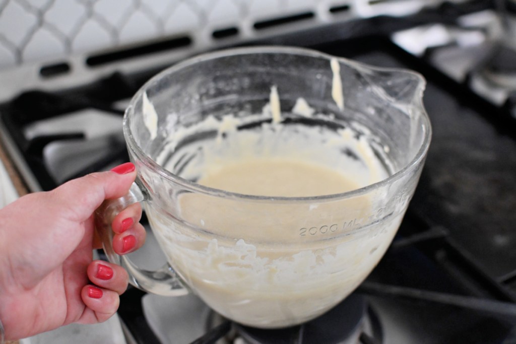 holding a batter bowl with homemade pancakes