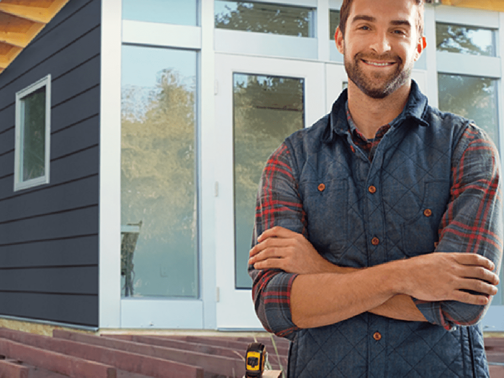 man standing in front of shed outside