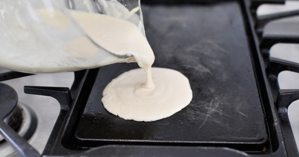 pouring pancakes on a griddle