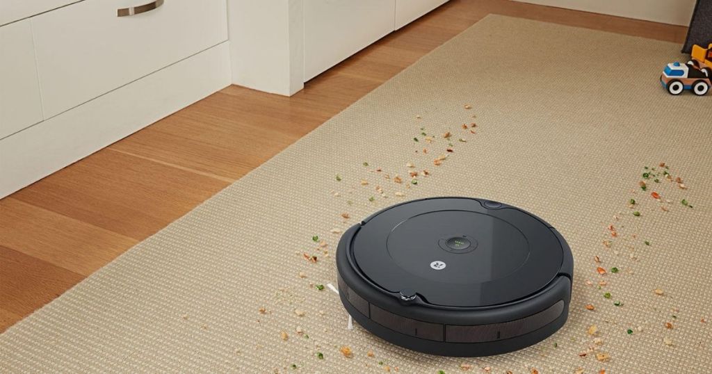 robot vacuum cleaning up debris on carpet