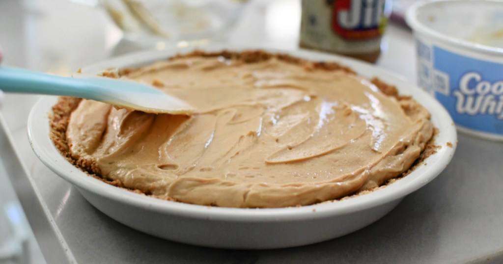 spreading peanut butter pie