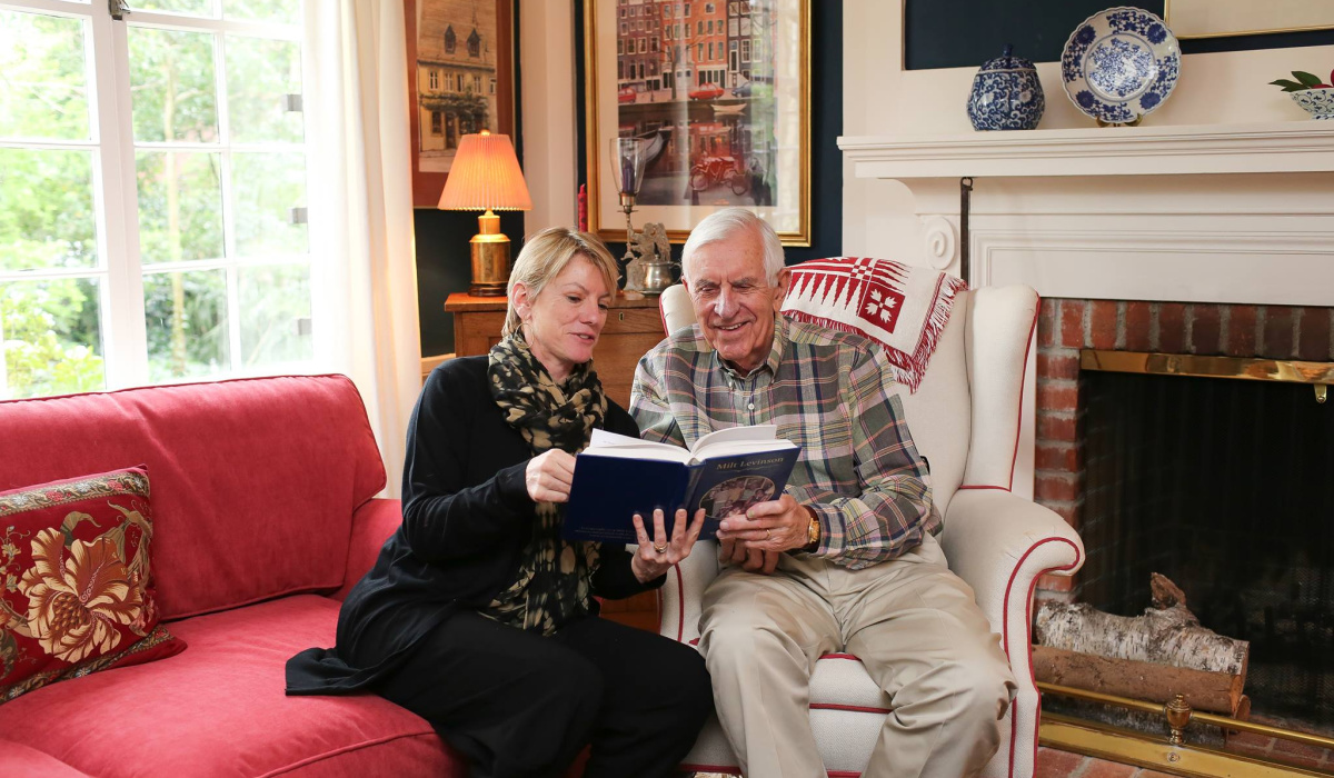 man an woman reading storyworth book