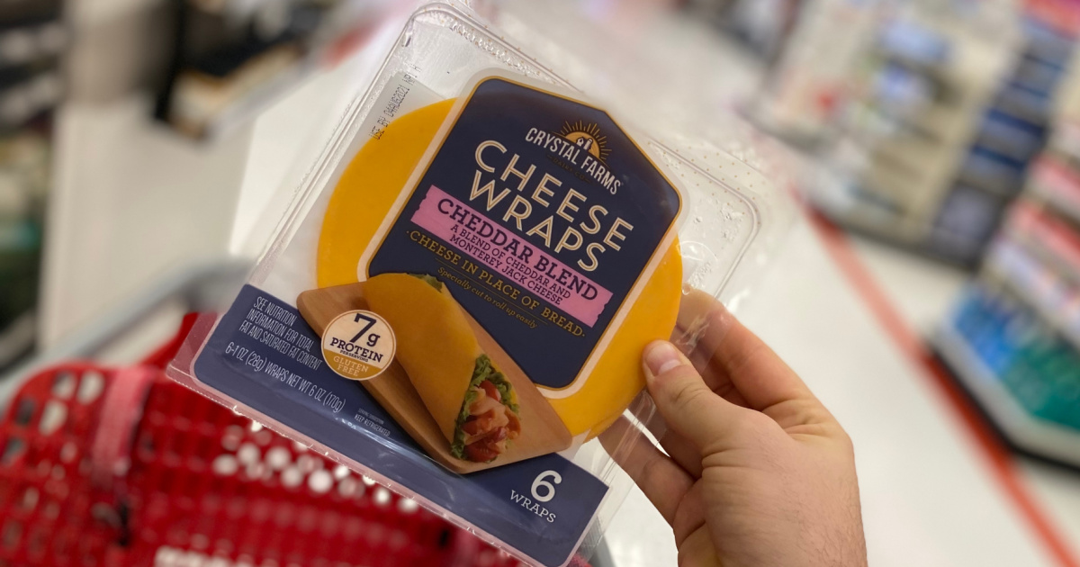 hand holding up a pack of cheese wraps above a Target cart in a store aisle