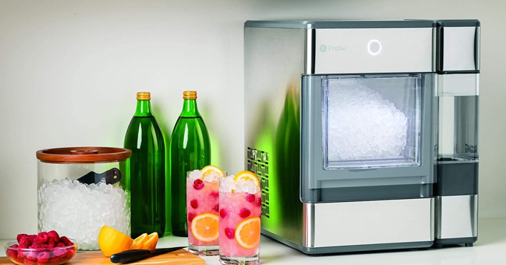 large ice maker next to drinks and glasses