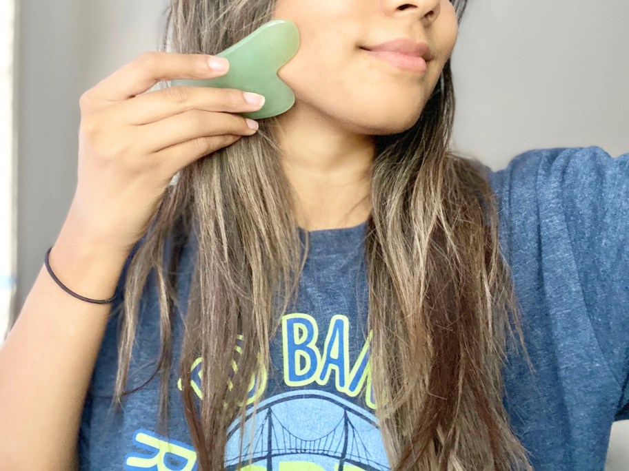 girl using green gua sha