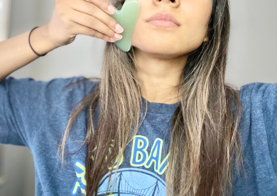 girl holding gua sha