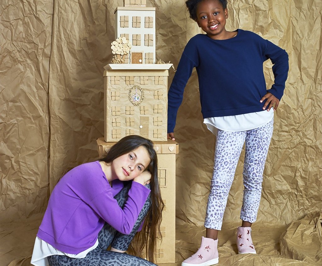 two girls by a tower of blocks