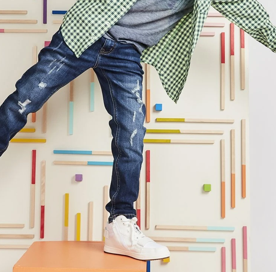 boy standing on a block on one foot