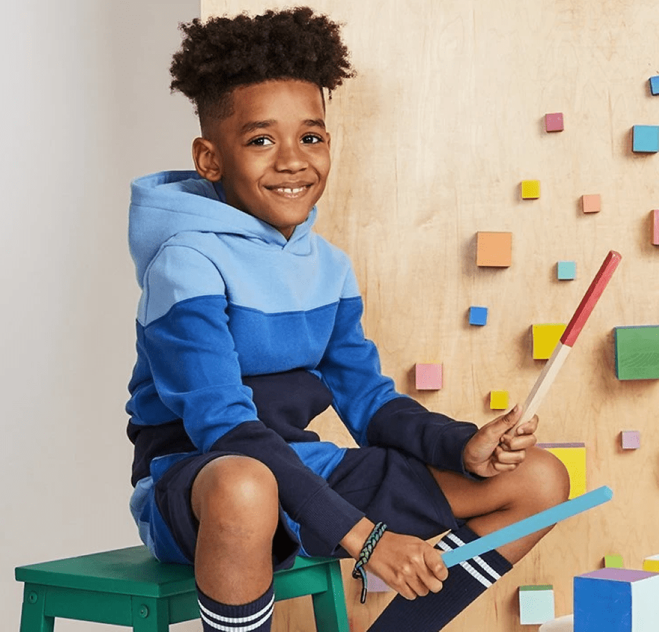 boy playing with drumsticks