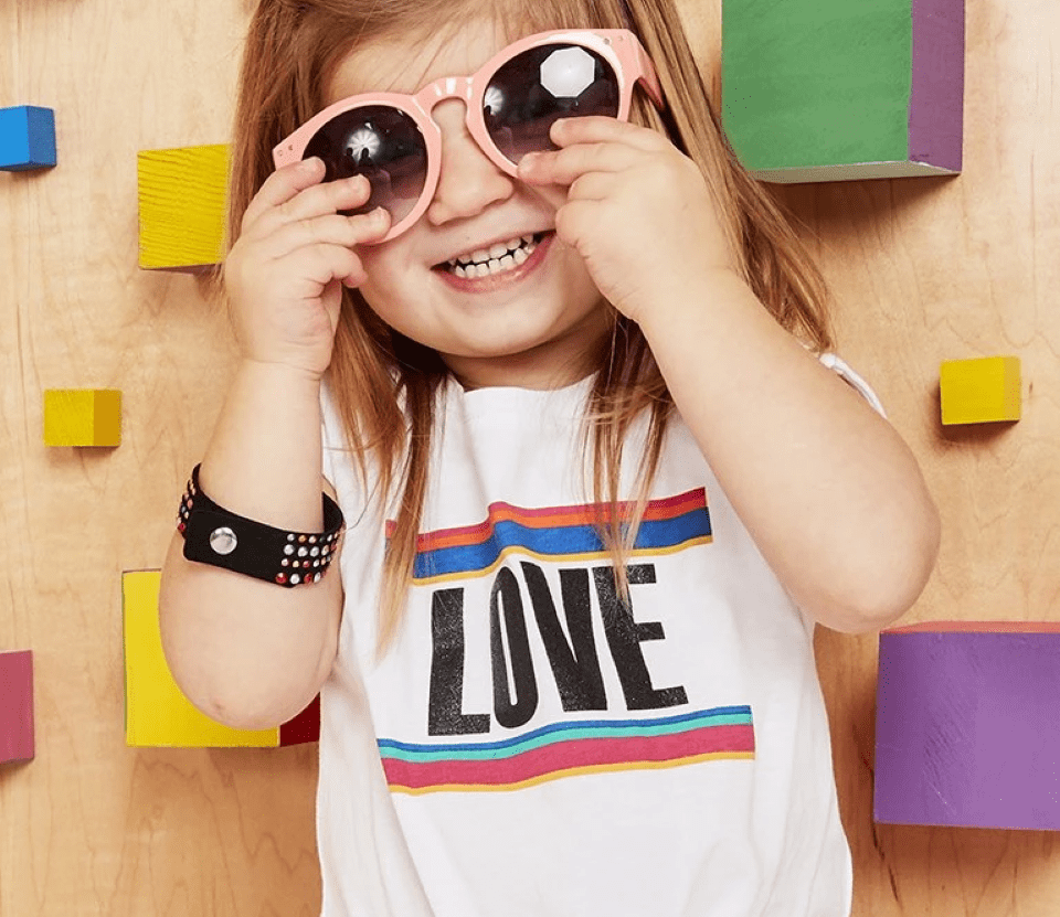 toddler girl holding her sunglasses