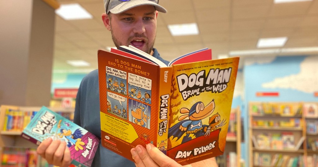 man holding a dog man book