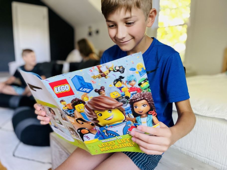 boy reading a LEGO Life magazine