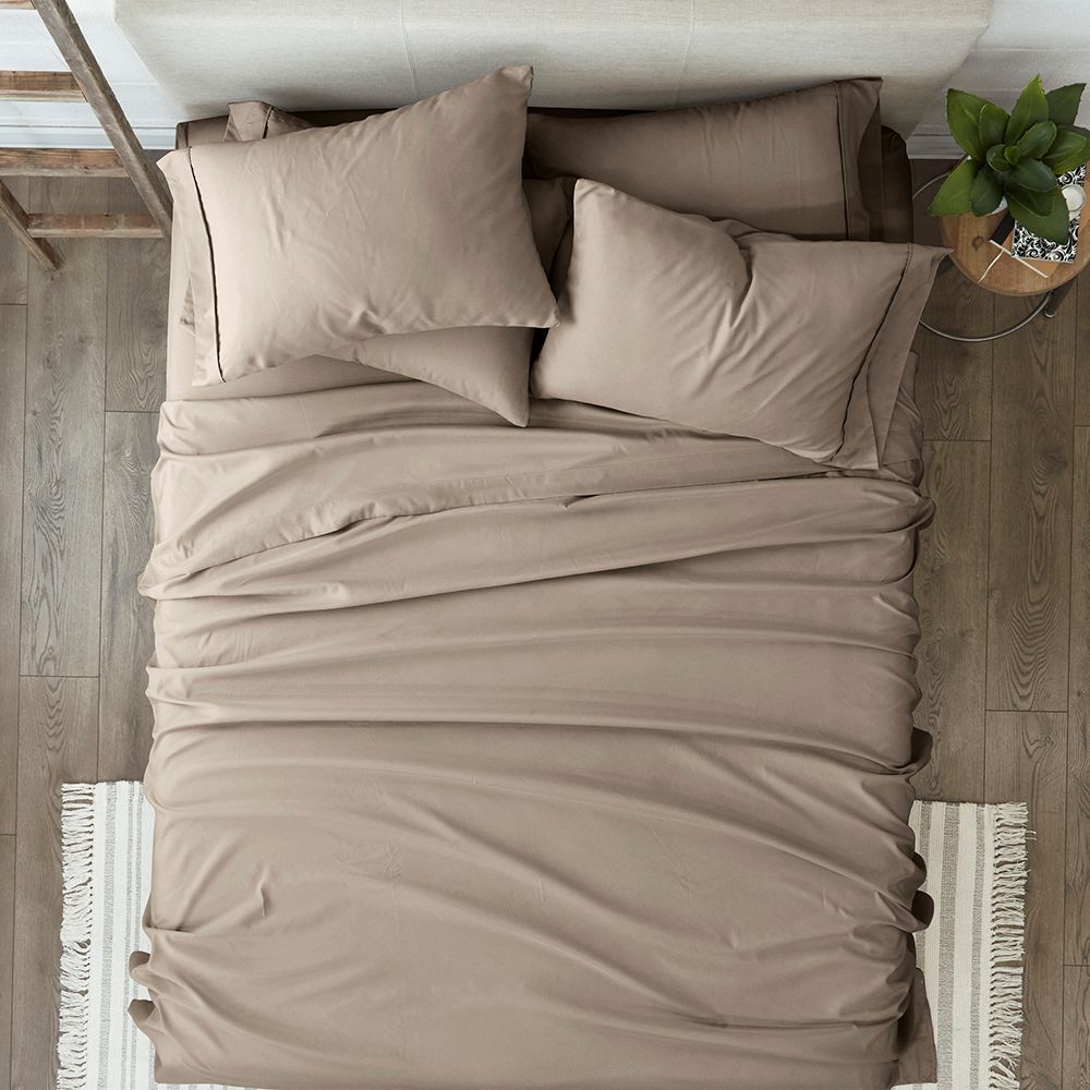 bed with sheets and pillows on it