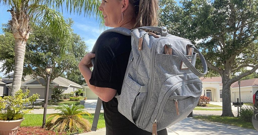 woman carrying gray dipper bag backpack