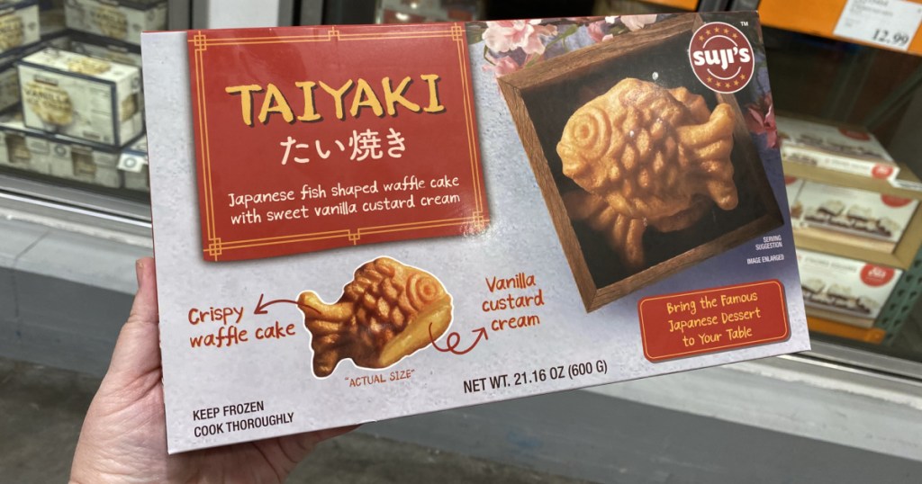 hand holding a box of Suji’s Taiyaki Fish Waffles 