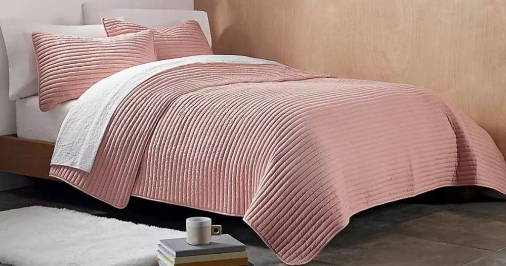 bed with a pink blanket on it