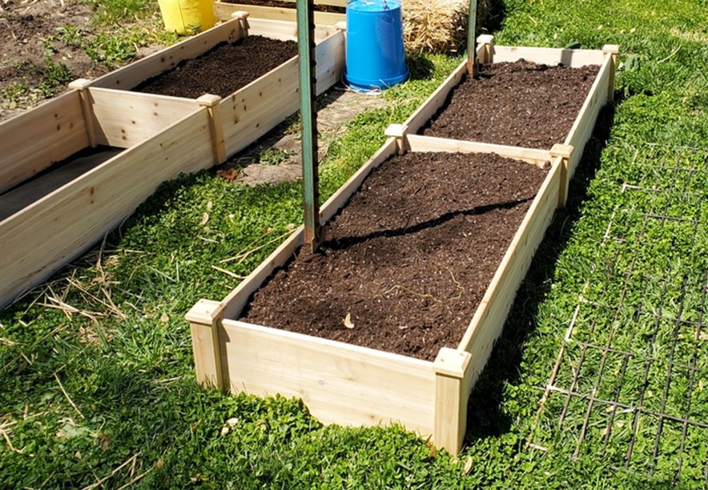 raised garden bed in grass filled with dirt