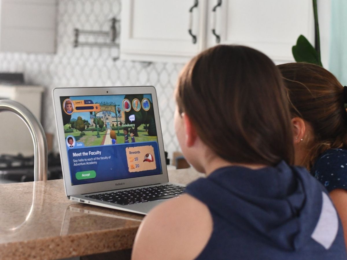 2 girls playing onlineputer game on laptop