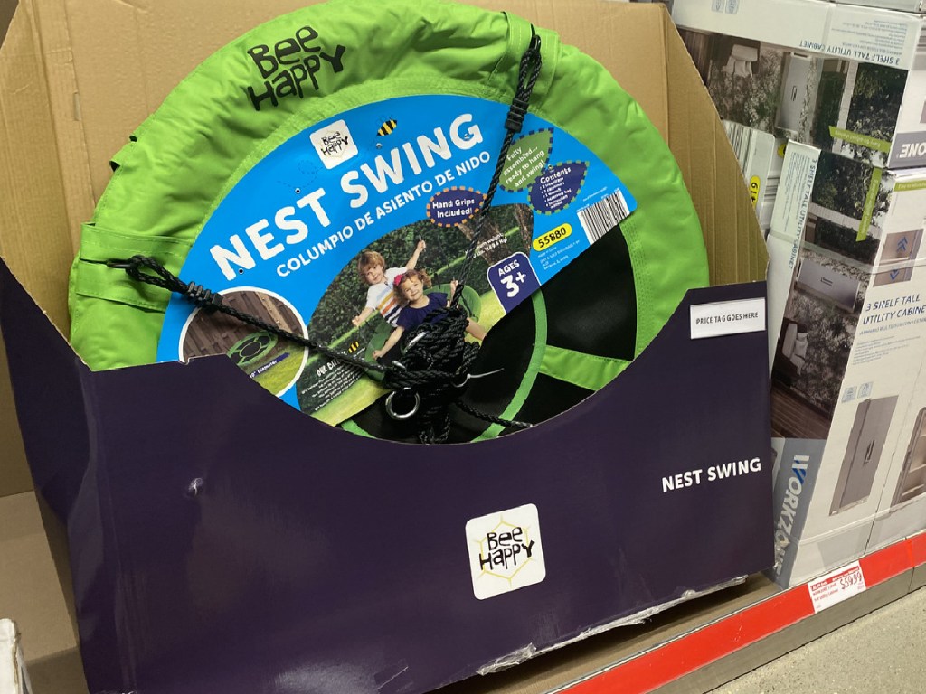 large green mesh swing that kids sit on at store display