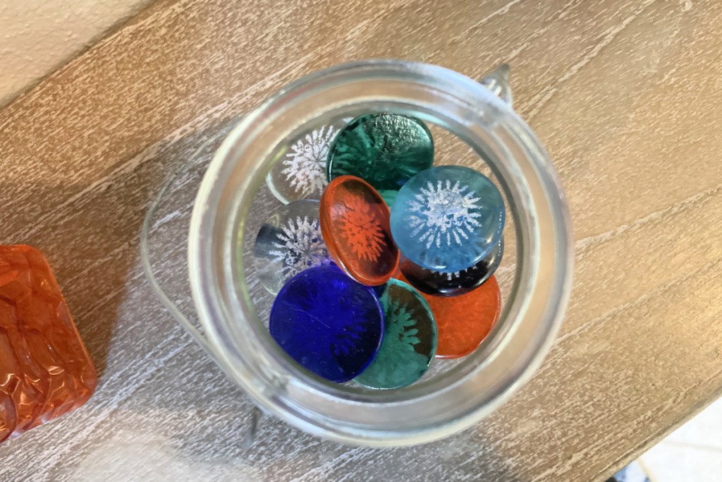 cremation jewelry sharing stones in glass container on table