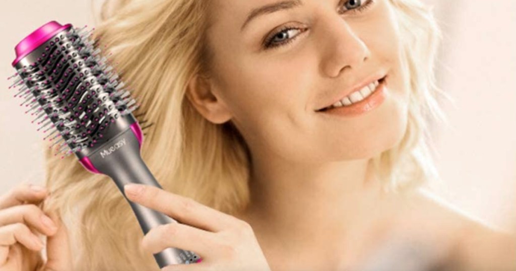 woman using hair dryer: styler