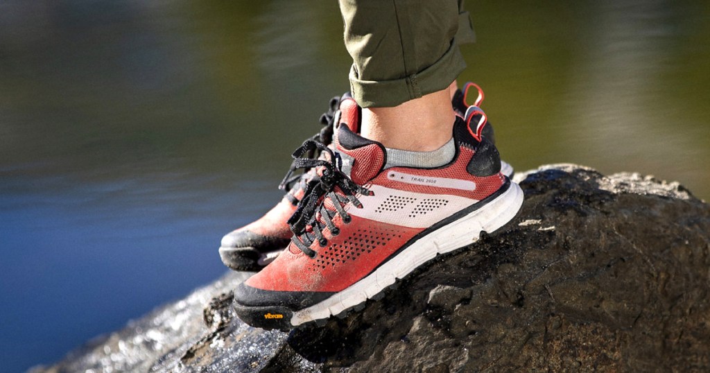 woman wearing hiking shoes by lake 