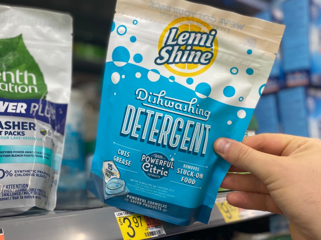 hand holding bag of dishwasher tabs on store shelf