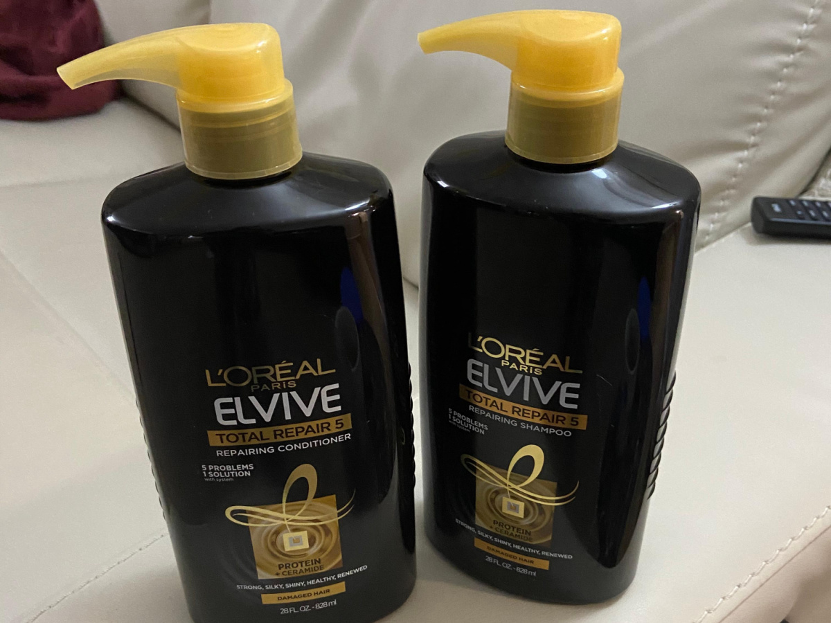 2 black and gold shampoo and conditioner bottles