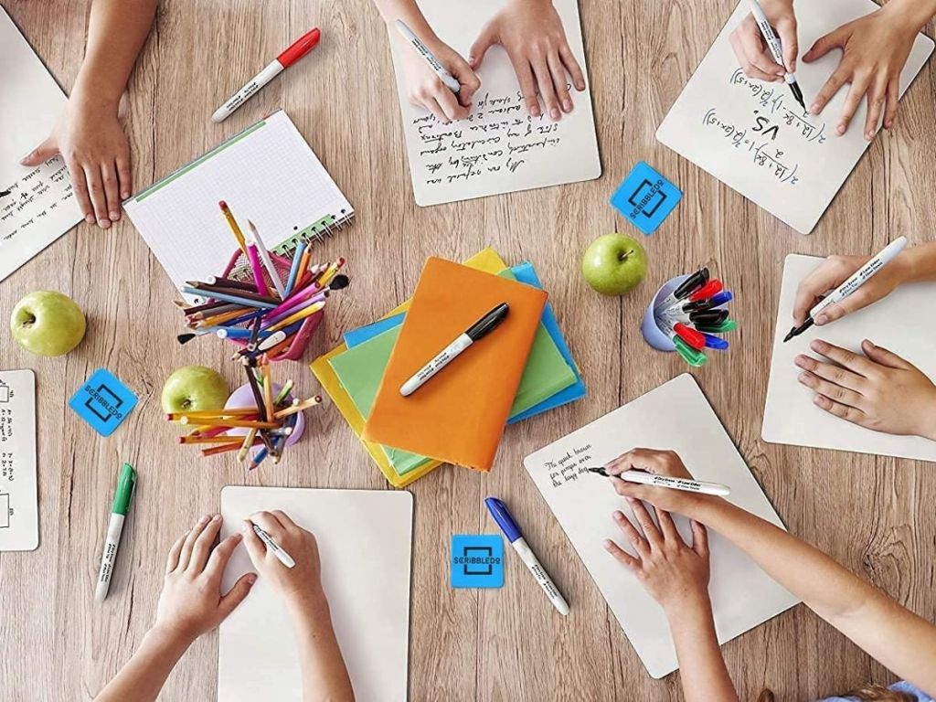 kids using mini whiteboards to do homework