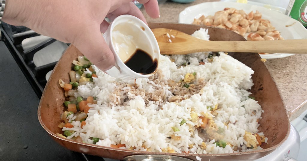 pouring soy sauce over rice 