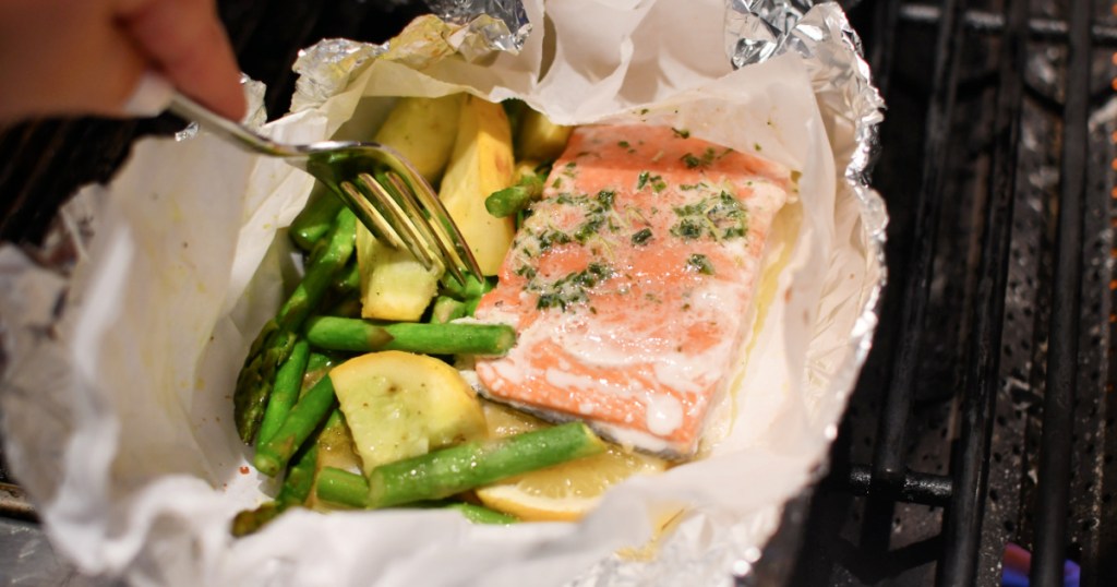 salmon and veggies foil packet meal on the grill