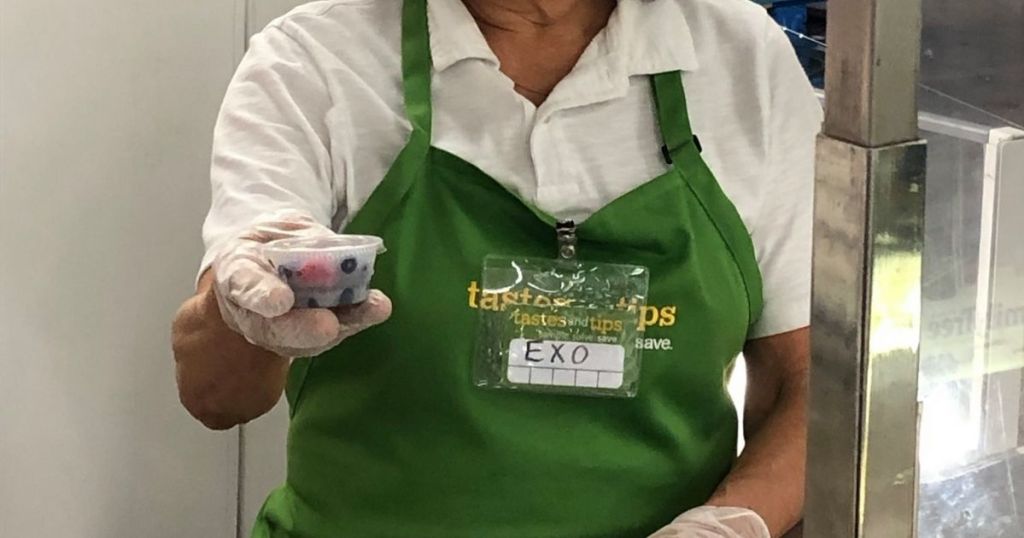 Sam's Club employee holding sealed free sample