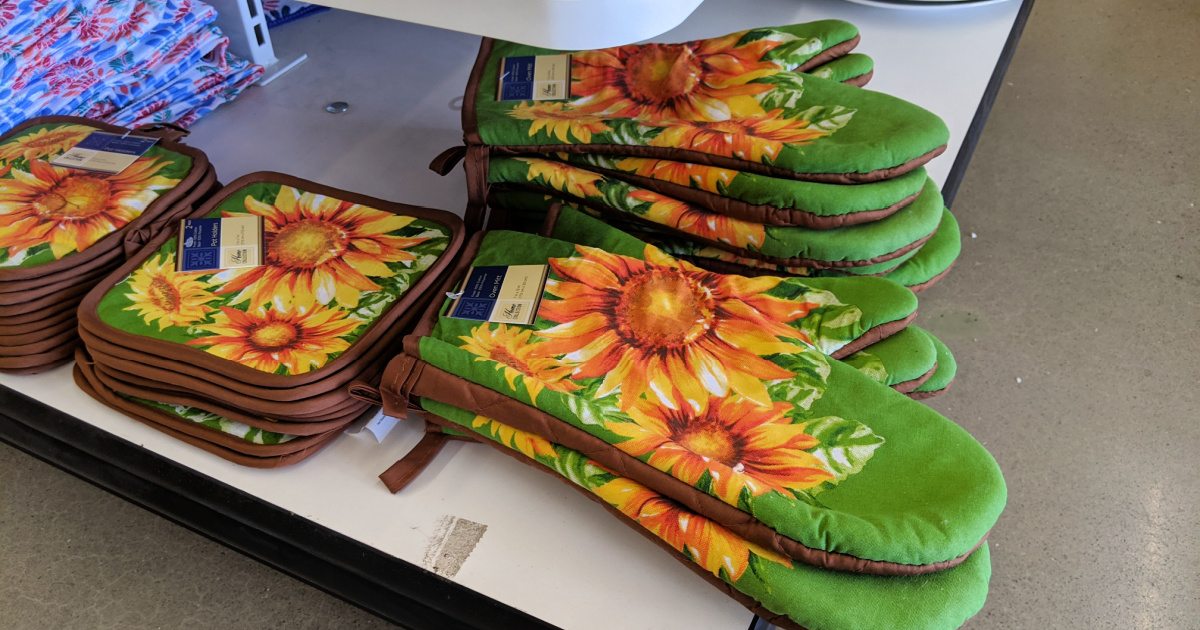 sunflower print potholders and oven mitts on a store display