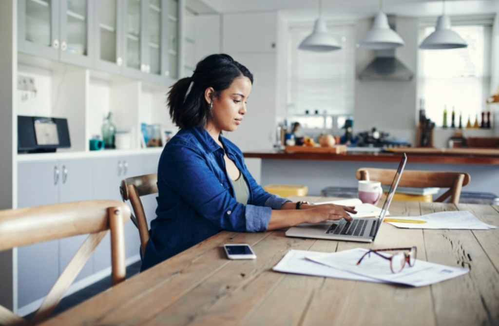 woman using laptop in kitchen