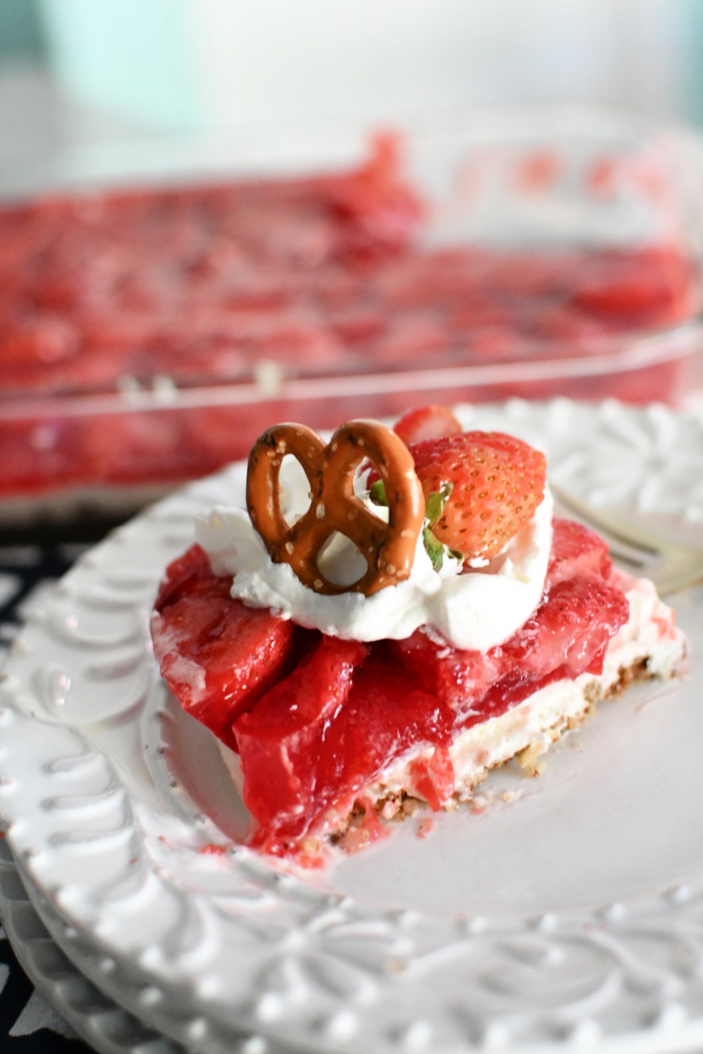 strawberry pretzel salad recipe on a white plate 