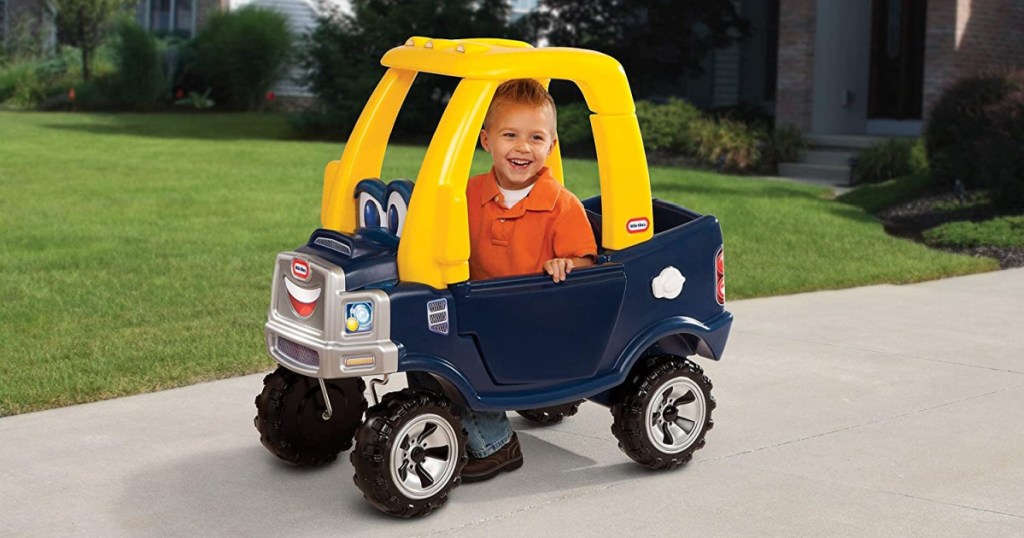 little boy in a toy car