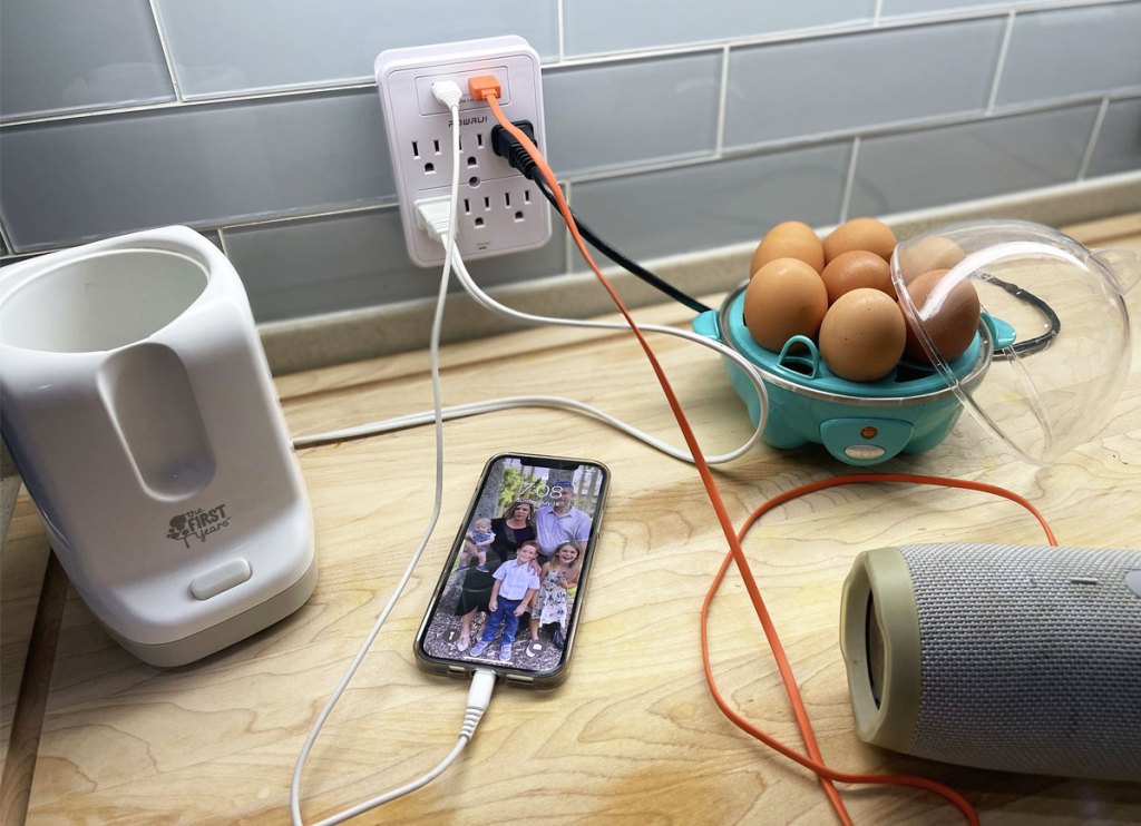 phone and multiple kitchen appliances plugged into wall charger