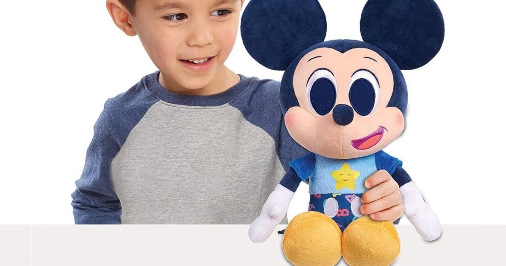 boy holding Mickey Mouse plush