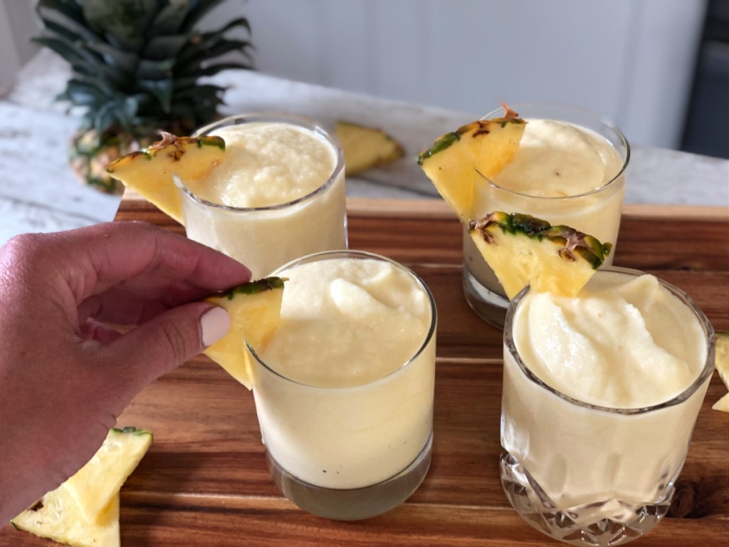 adding a garnish to pina coladas