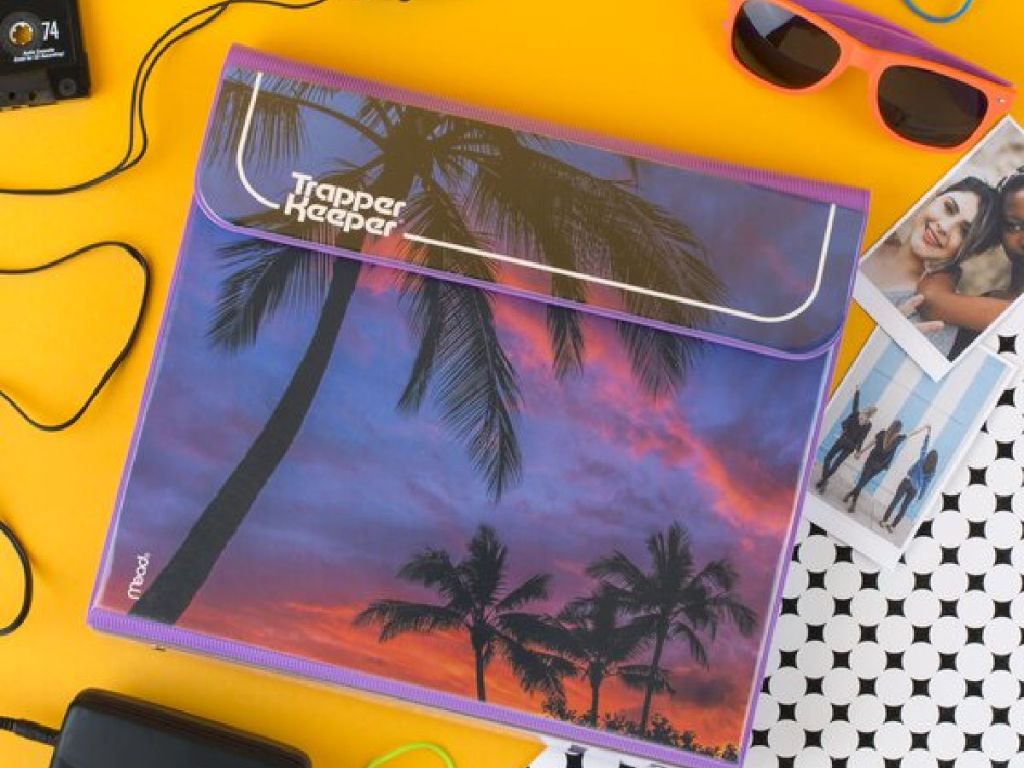 Trapper Keeper Binder with Palm Trees design on desk