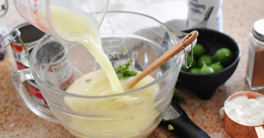 adding key lime juice and zest to key lime pie