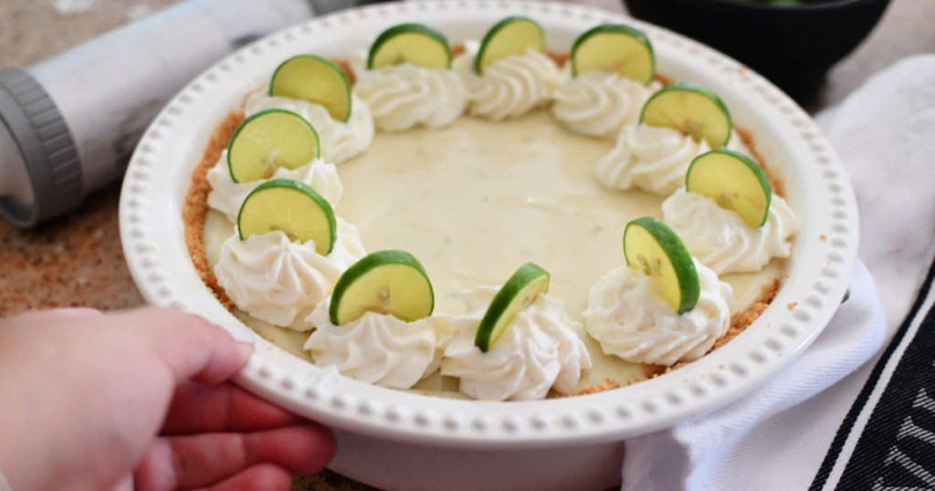 adding whipped cream to pie