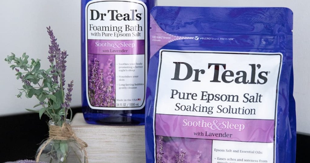 Dr. Teals Epsom Salt and bath soaking solution with a lavender plant to the left of them