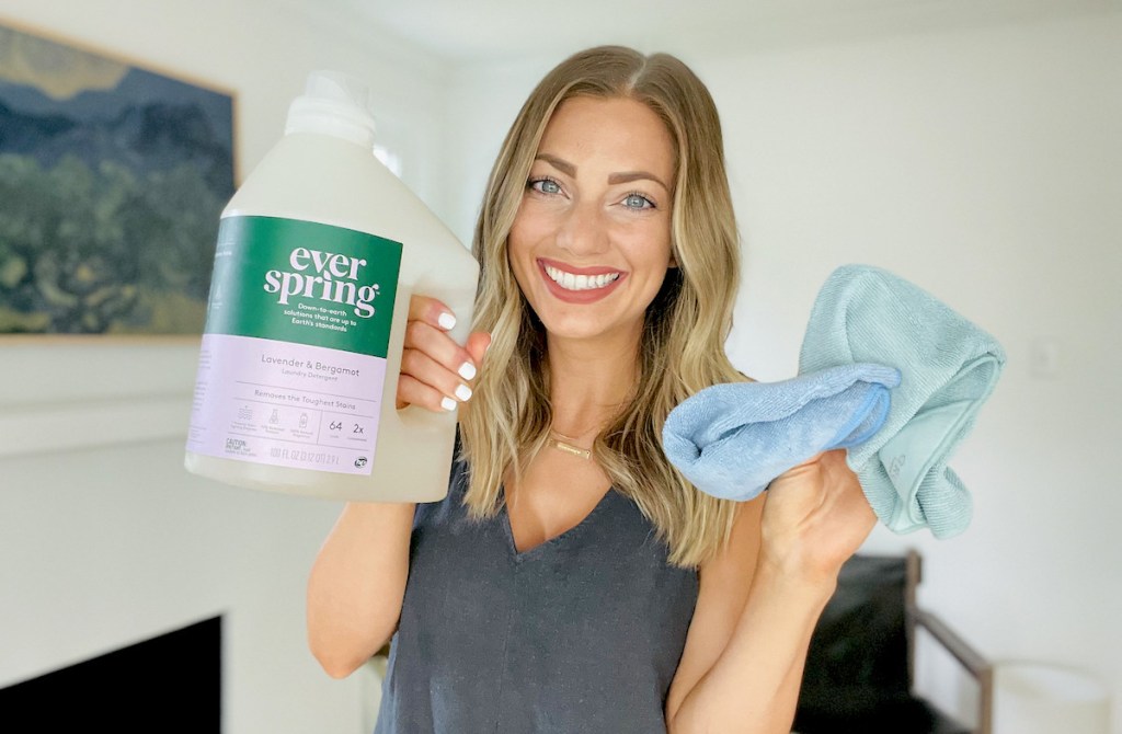 woman holding jug of ever spring laundry detergent 