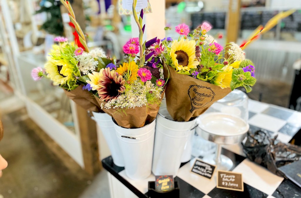 bouquets of colorful farm fresh flowers in farmers market stand